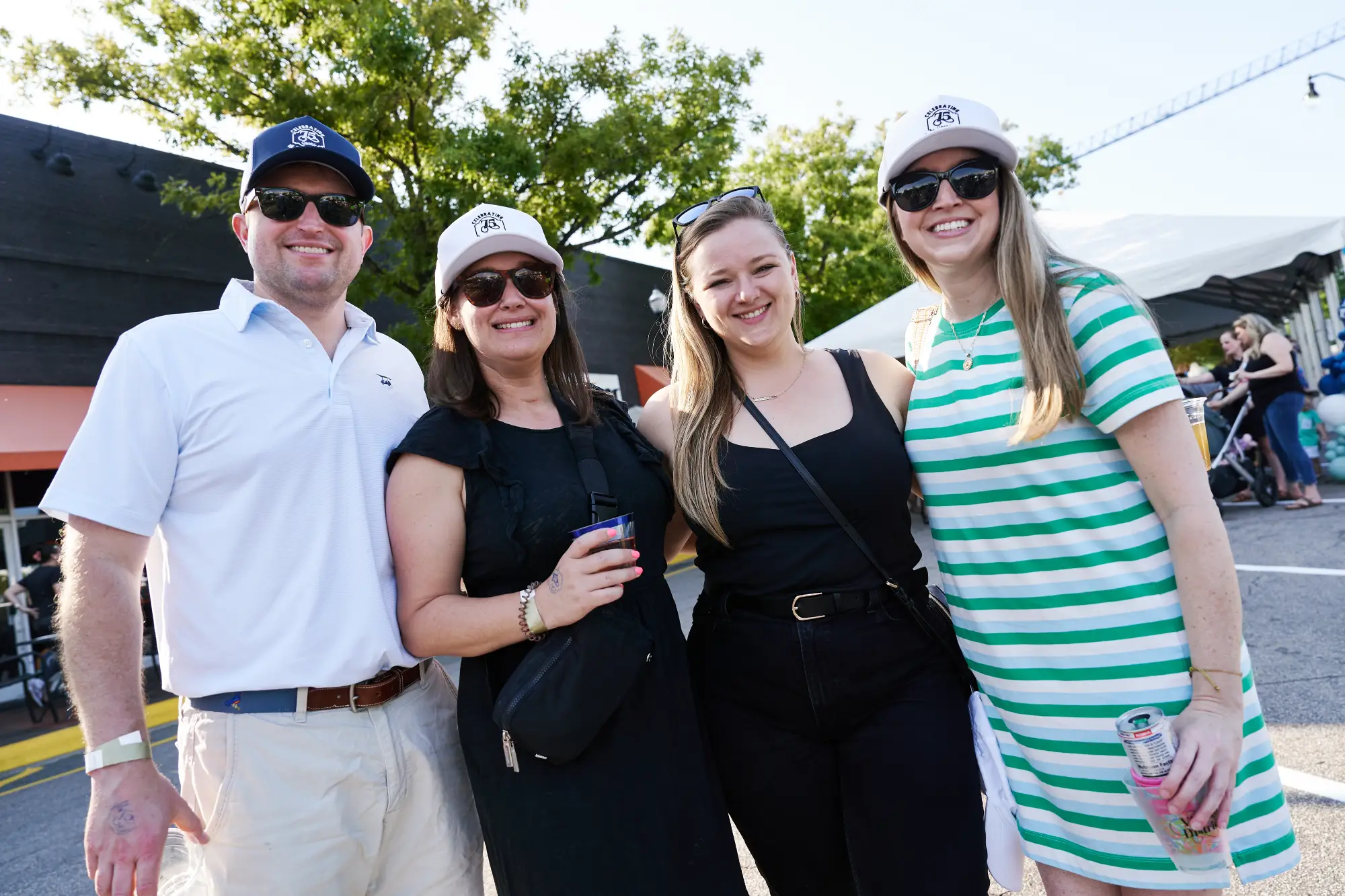 Friends smiling at camera at Village District 75th Anniversary Celebration