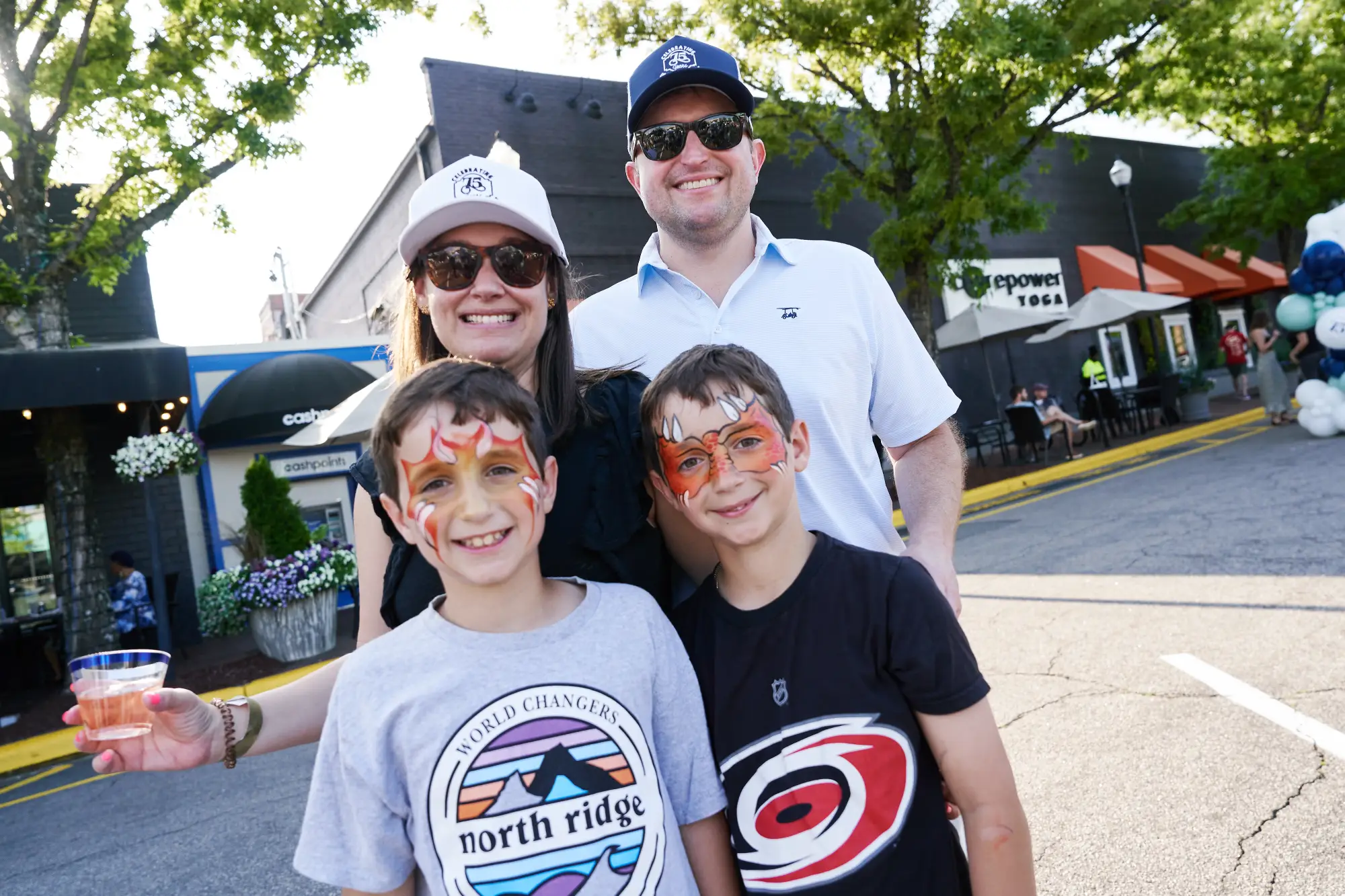 Boys with face paint smiling with their parents