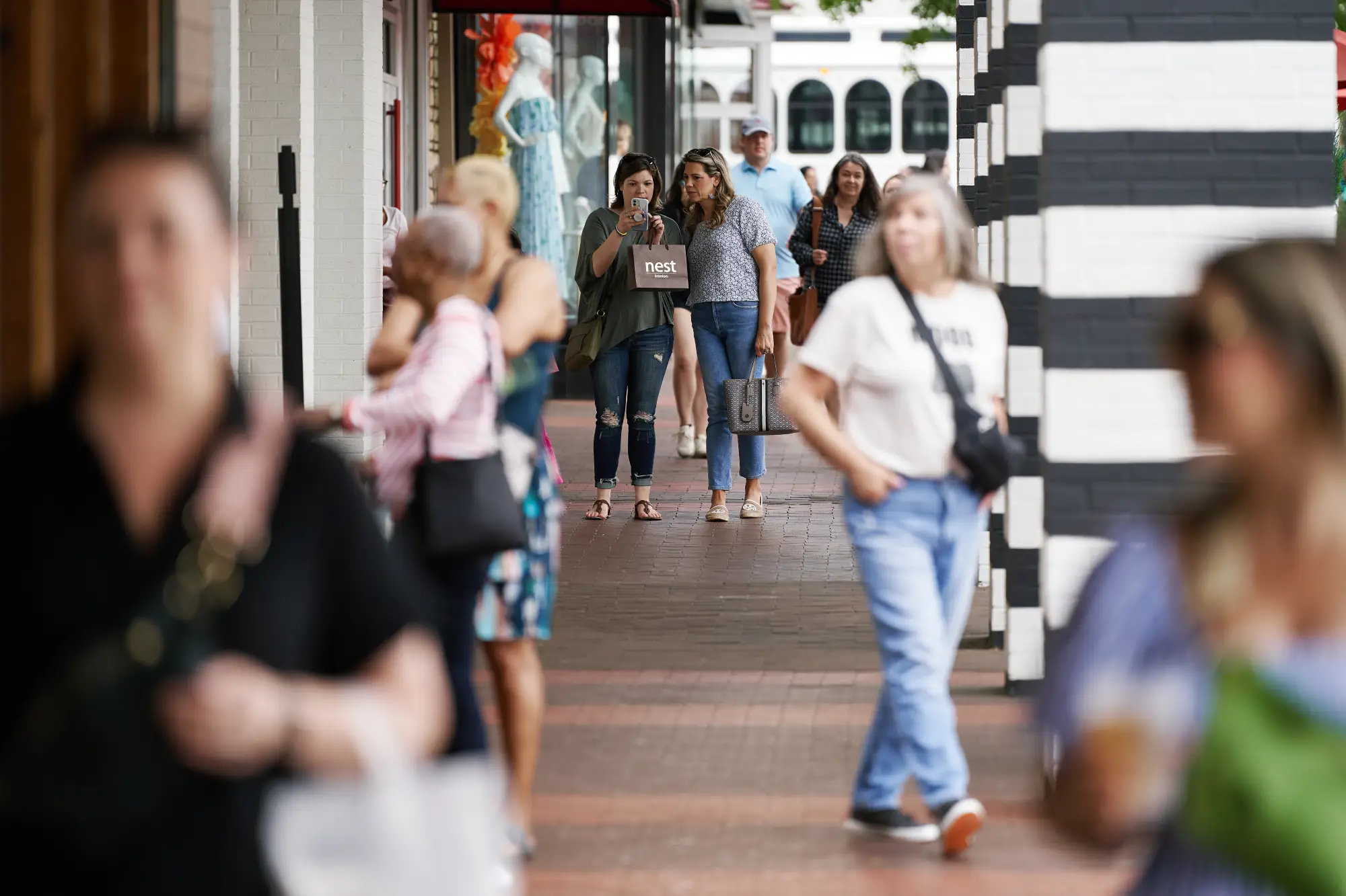 people walking outside stores at Village District