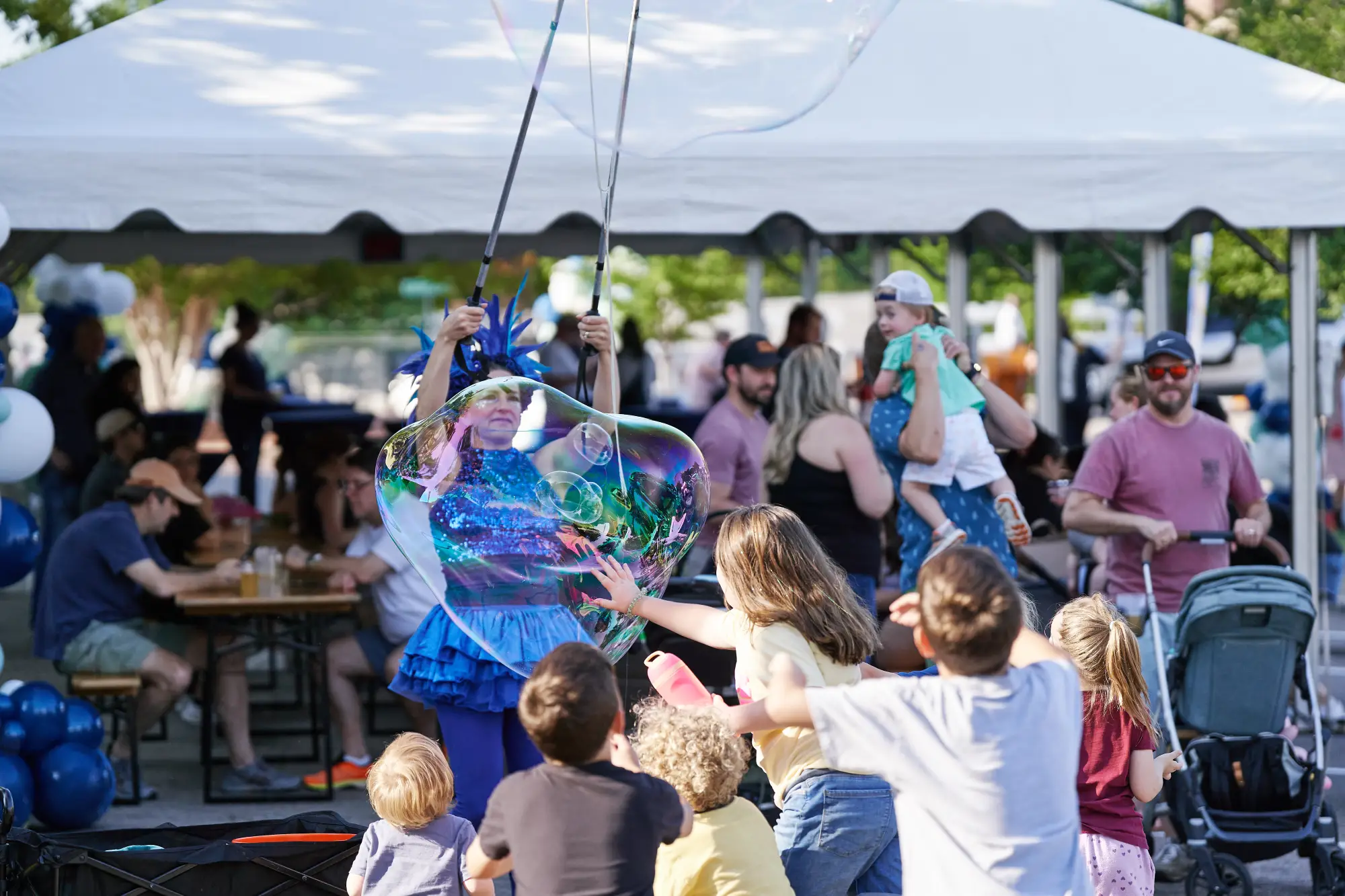 Bubble maker playing with children