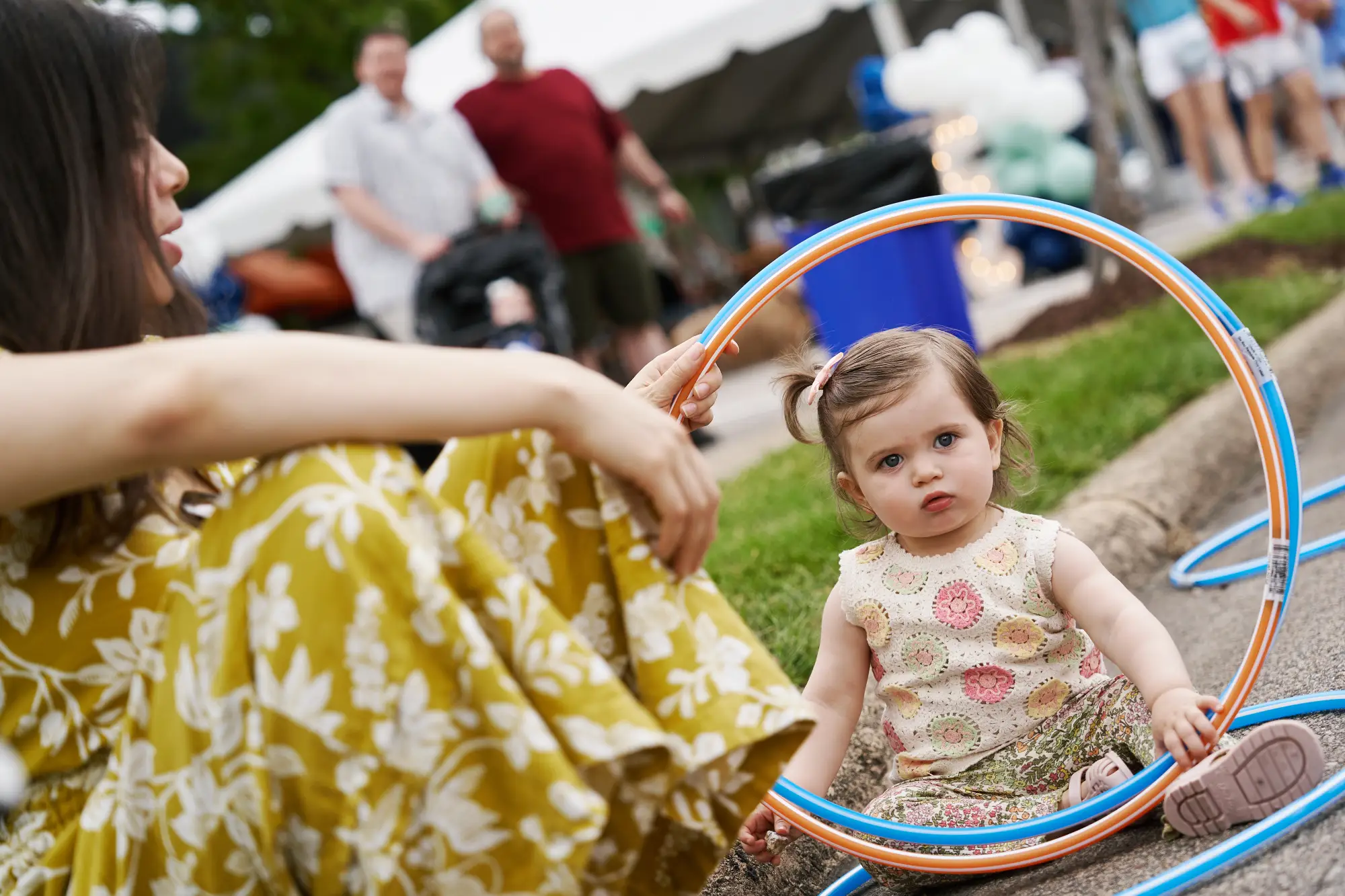 baby looking through a hula-hoop