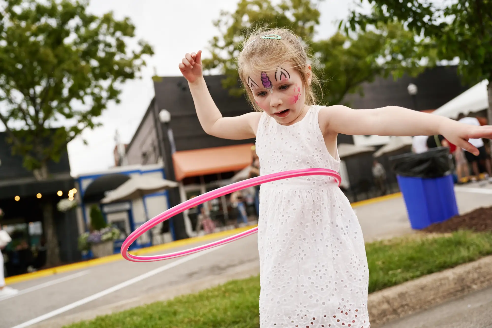 Little girl with face paint and hula hoop