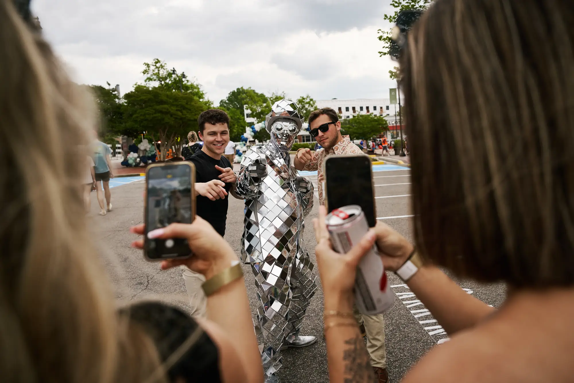 posing with man in mirrored suit