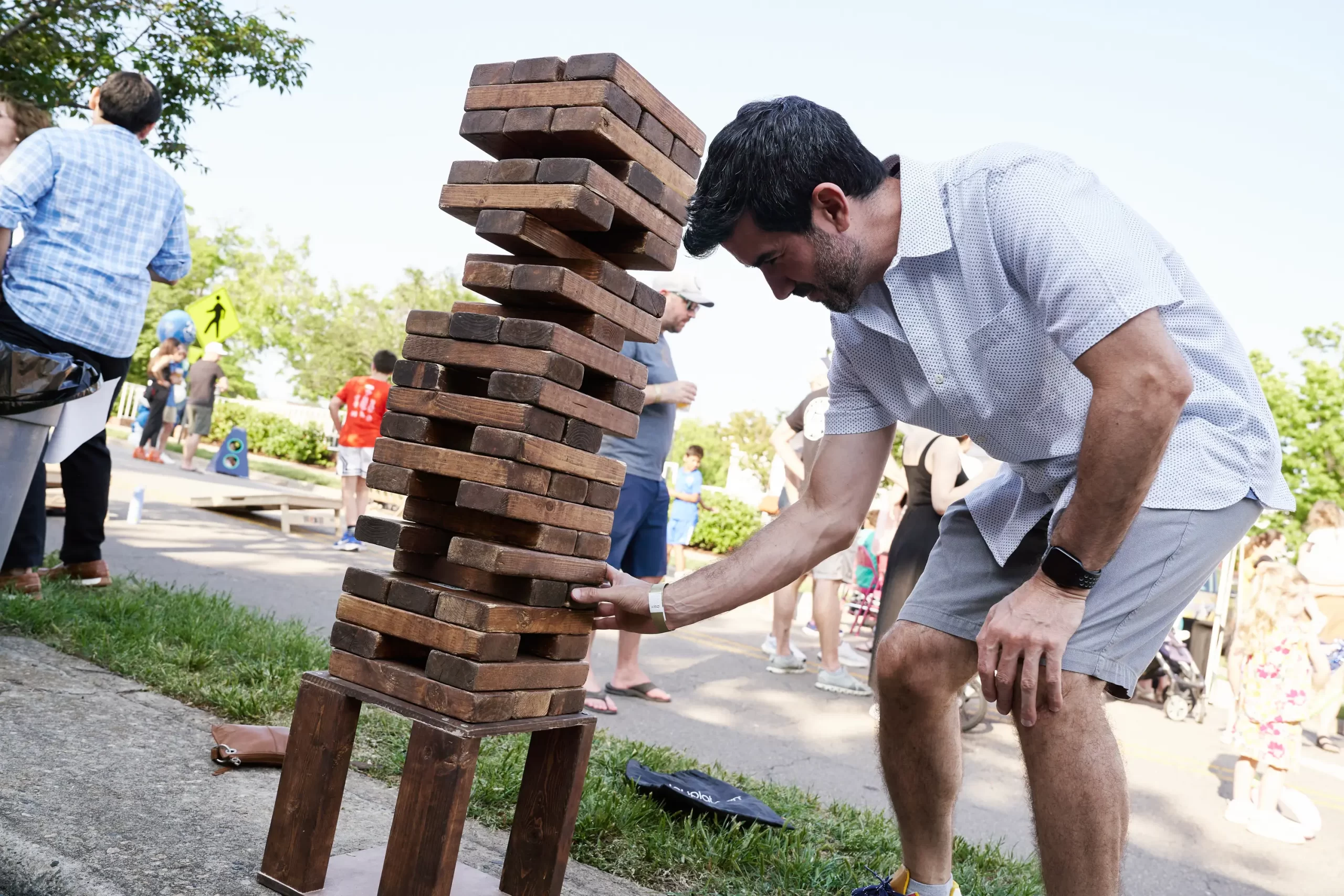 a guy playing Jinga at Village District 75th Anniversary Celebration